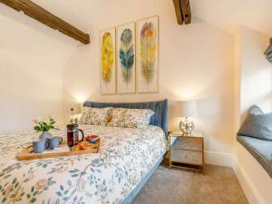 a bedroom with a bed with a tray of fruit on it at 1 Bed in Hope Valley oc-89720 in Hope