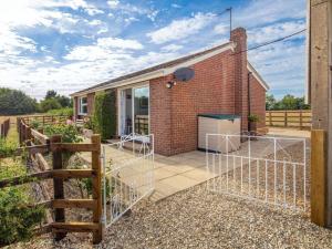 a brick house with a gate in front of it at 3 Bed in Aylesbury oc-88963 in Shabbington