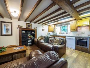 a living room with couches and a table and a kitchen at 3 Bed in Hope Valley oc-pk432 in Aston