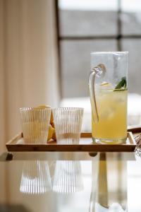 a tray with a drink and some cups on a table at Villa Volcano by CasasBlancas in Yaiza