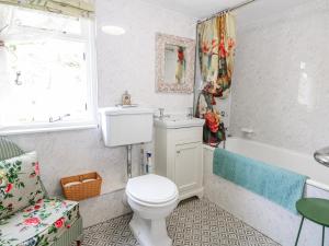 a bathroom with a toilet and a tub and a sink at Quince Cottage in Lewes +24 photos