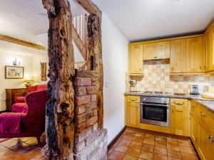 a kitchen with a brick wall in the middle of it at 2 Bed in Shrewsbury oc-86590 in Leighton
