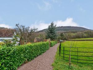 a gravel path leading to a field with a fence at 2 Bed in Shrewsbury oc-86590 in Leighton