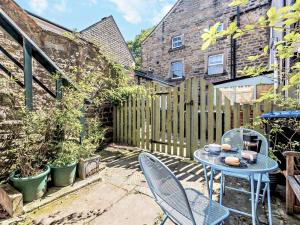 a patio with a table and chairs and a fence at 3 Bed in Baslow oc-pk908 in Baslow