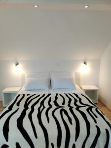 a zebra print bed in a room with two tables at VILLa LIKA A NNEX in Plitvička Jezera +18 photos