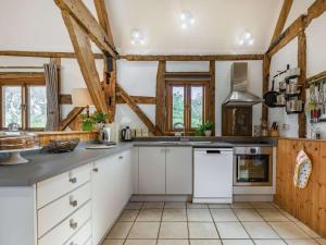 a kitchen with white cabinets and wooden beams at 4 Bed in Ludlow oc-chl22 in Orleton +16 photos