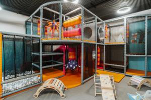 a play room with a playground with a slide at OREA Resort Panorama Moravský kras in Blansko +88 photos