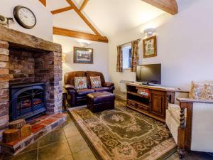 a living room with a fireplace and a tv at 1 Bed in Leighton oc-80726 in Leighton