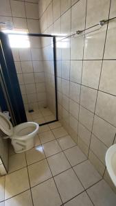 a bathroom with a toilet and a sink at Império Hotel in Costa Rica +7 photos