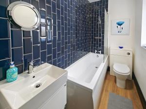 a bathroom with a sink and a toilet and a mirror at 3 Bed in Morpeth oc-96236 in Amble +14 photos