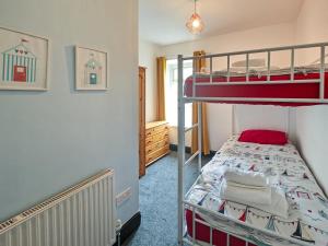 a bedroom with two bunk beds in a room at 3 Bed in Morpeth oc-96236 in Amble