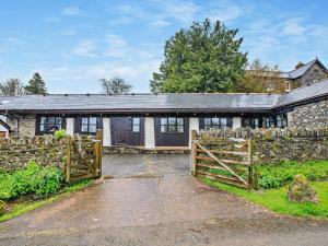 an old stone house with a gate in front of it at 2 Bed in Dulverton oc-90558 in Dulverton