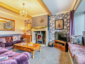 a living room with a couch and a fireplace at 6 Bed in Huddersfield oc-93984 in Huddersfield
