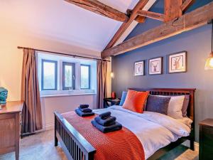 a bedroom with a large bed with blue walls at 6 Bed in Huddersfield oc-93984 in Huddersfield