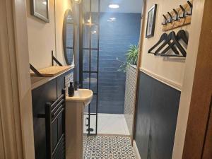 a bathroom with a shower with a sink and a mirror at 6 Bed in Huddersfield oc-93984 in Huddersfield +26 photos