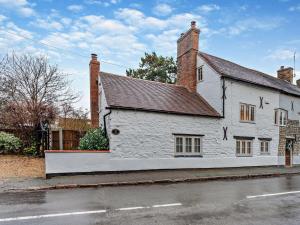 a white building with a roof on a street at 3 Bed in Warwick oc-93887 in Kineton