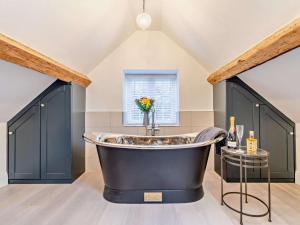 a large bathroom with a large tub in a attic at 3 Bed in Warwick oc-93887 in Kineton +25 photos