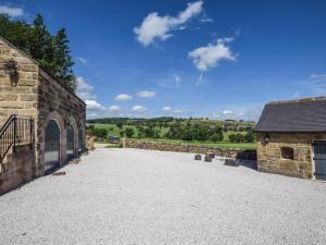 a stone building with a large driveway in front of it at 1 Bed in Bakewell oc-91367 in Youlgreave +8 photos