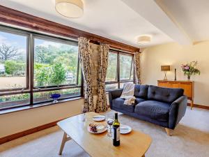a living room with a couch and a table at 2 Bed in Kidderminster oc-90642 in Stottesden