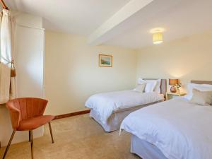 a hotel room with two beds and a chair at 2 Bed in Kidderminster oc-90642 in Stottesden