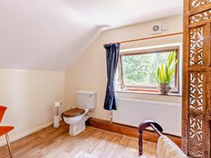 a bathroom with a toilet and a window at 2 Bed in Kidderminster oc-90642 in Stottesden +24 photos