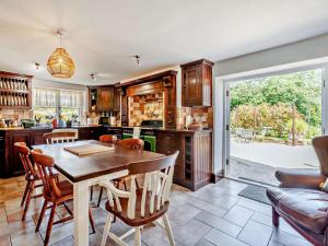 a kitchen with a table and chairs in a room at 8 Bed in Bristol oc-87469 in Winterbourne