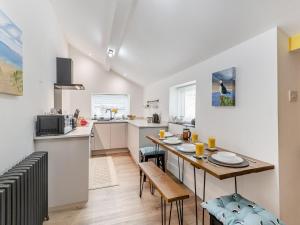 a kitchen with a table and a dining room at 2 Bed in Morpeth oc-91206 in Amble