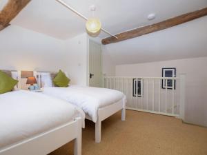 two beds in a room with white walls and wooden ceilings at 2 Bed in Ludlow oc-40329 in Ludlow