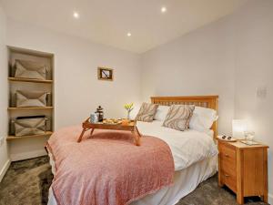 a bedroom with a bed with a table on it at 2 Bed in Aberdovey oc-91962 in Aberdyfi