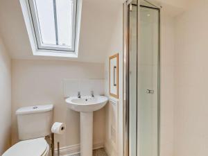 a bathroom with a toilet and a sink and a window at 2 Bed in Warwick oc-93085 in Warwick +17 photos