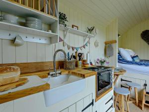 a kitchen with a sink and a stove at 1 Bed in Hereford oc-93440 in Little Dewchurch