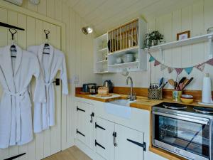 a kitchen with white towels hanging on the wall at 1 Bed in Hereford oc-93440 in Little Dewchurch