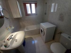 a bathroom with a sink and a toilet and a window at Marcolina, 2 in Alcalà de Xivert +14 photos