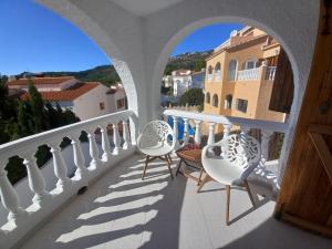 a balcony with chairs and a view of a city at Marcolina, 2 in Alcalà de Xivert