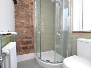 a bathroom with a glass shower with a toilet at 1 Bed in Buxton oc-58958 in Flash