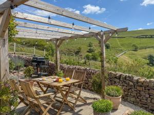 a wooden table and chairs under a wooden pergola at 1 Bed in Buxton oc-58958 in Flash