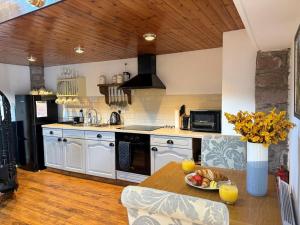 a kitchen with a table with a bowl of fruit on it at 1 Bed in Buxton oc-58958 in Flash