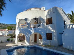 a white house with a swimming pool in front of it at Marcolina, 2 in Alcalà de Xivert