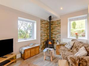 a living room with a couch and a fireplace at 1 Bed in Buxton oc-74351 in Flash