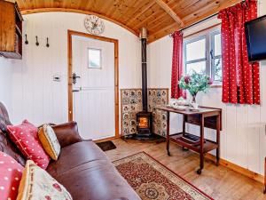 a living room with a couch and a wood stove at 1 Bed in Shrewsbury oc-80587 in Leighton