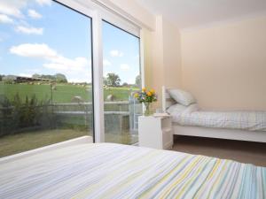 a bedroom with a bed and a large glass window at 2 Bed in Bristol oc-75697 in Bristol