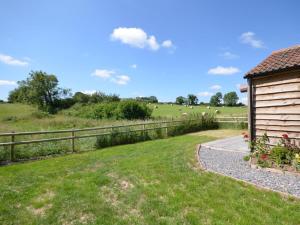 a house with a fence and sheep in a field at 2 Bed in Bristol oc-75697 in Bristol