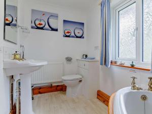 a bathroom with a toilet and a sink and a tub at 3 Bed in Monmouth oc-52149 in Welsh Newton Common +17 photos