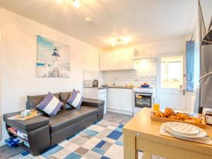 a living room with a couch and a kitchen at 1 Bed in Filey oc-77709 in Hunmanby