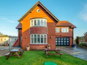 a house with two picnic tables in front of it at 1 Bed in Filey oc-77709 in Hunmanby