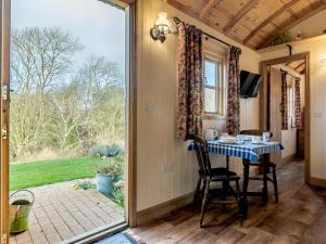 a dining room with a table and a window at 1 Bed in Shrewsbury oc-77906 in Leighton