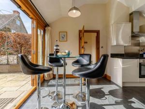 a kitchen with black stools and a table at 2 Bed in Ludlow oc-59293 in Lane to Richards Castle +15 photos