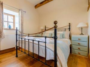 a bedroom with a bed and a dresser and a window at 2 Bed in Ludlow oc-59293 in Lane to Richards Castle