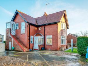 a red brick house with a garage at 1 Bed in Filey oc-77710 in Hunmanby