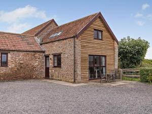 a brick house with a table in front of it at 1 Bed in Bristol oc-72835 in Chew Magna